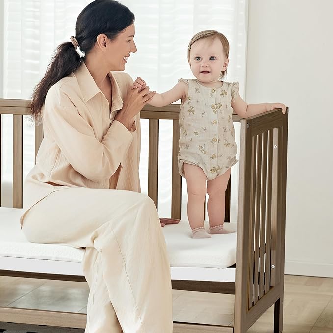 EvoNest Baby Crib, 6 in 1 Convertible Mini Crib with Wheels, 100% New Zealand Wood Growing Bed, 4 Adjustable Mattress Height，Walnut Brown (Walnut Brown)
