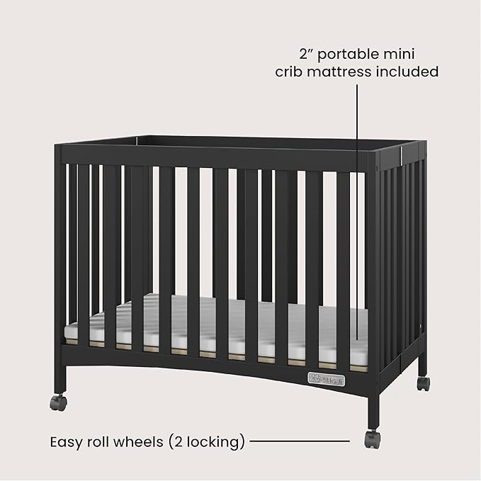 Child Craft London Mini Compact Folding Portable Crib with 2” Crib Mattress and 2 Easy Roll Locking Wheels, Durable Pine Wood Construction (Ebony Black)